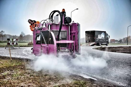 Industrial road-cutting machine at work